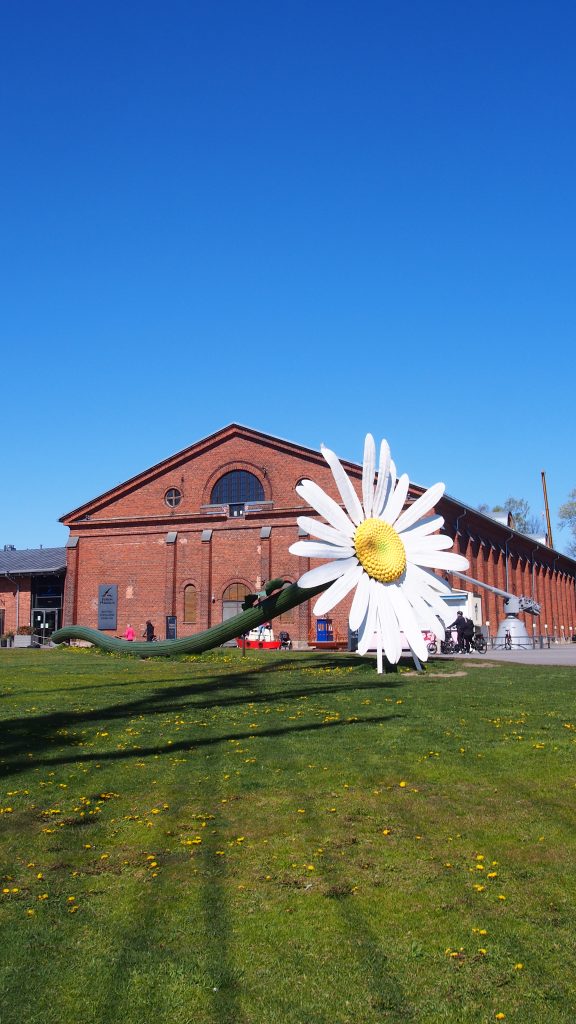 Giant daisy sculpture (Päivänkakkara) in Turku, Finland on a bright summer day.