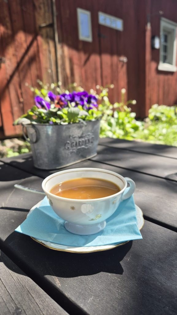 Cup of coffee at Café Qwensel in Turku, Finland on a sunny summer day.