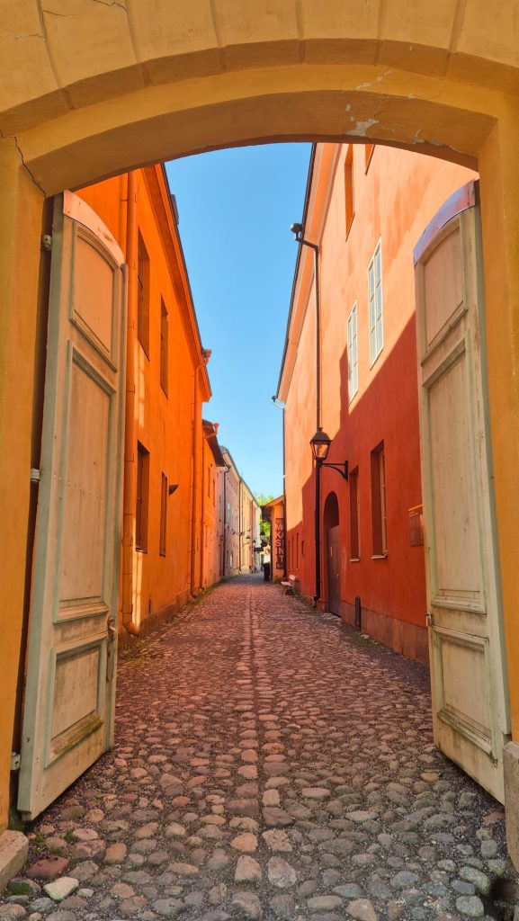 Historic colorful buildings along the cobblestone street of Luostarin Välikatu in Turku, Finland.