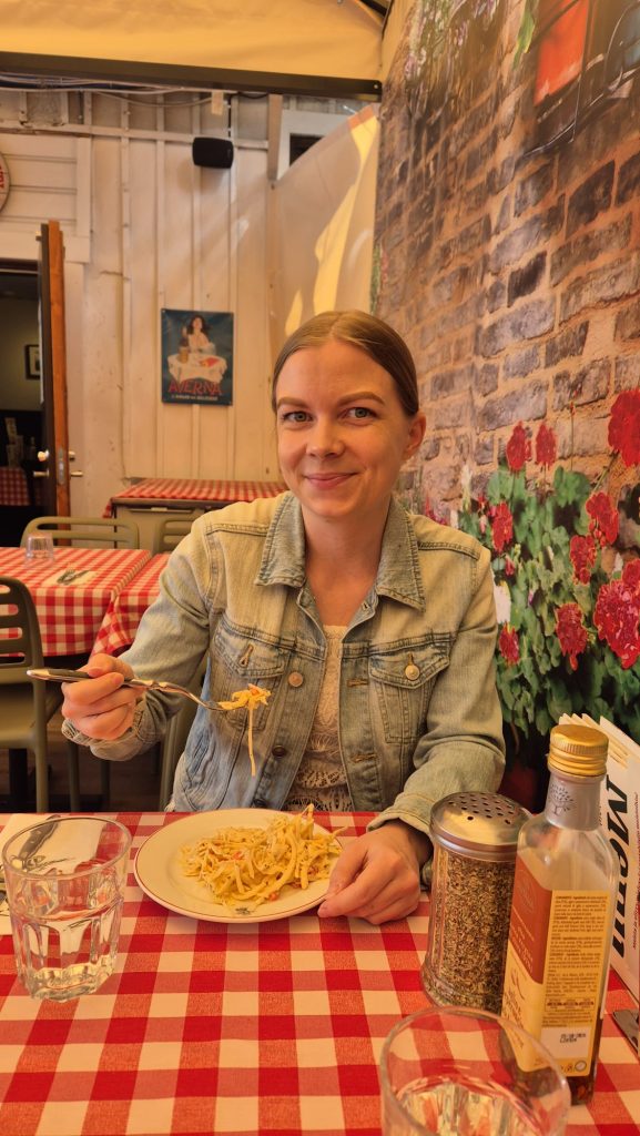 Me smiling to the camera while having lunch at Pizzeria Dennis in Turku, Finland.