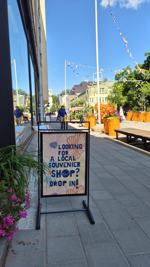 Turku street scene featuring KUI Design store sign, showcasing local Finnish design.
