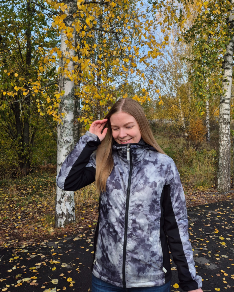 Person enjoying the colorful fall foliage in a Finnish forest.