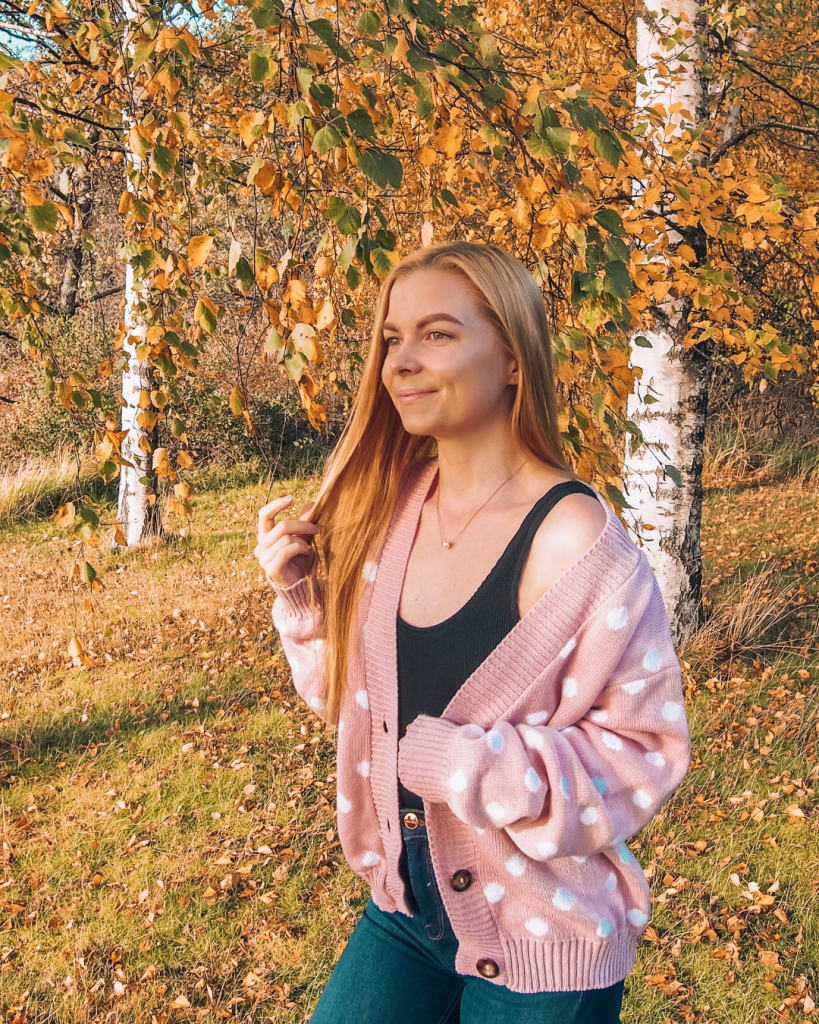 Person standing in front of colorful autumn trees in Finland.
