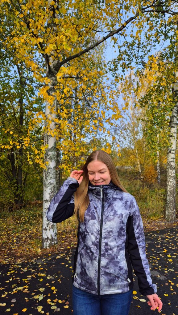 Autumn travel outfit in Finland: waterproof jacket for exploring outdoors.