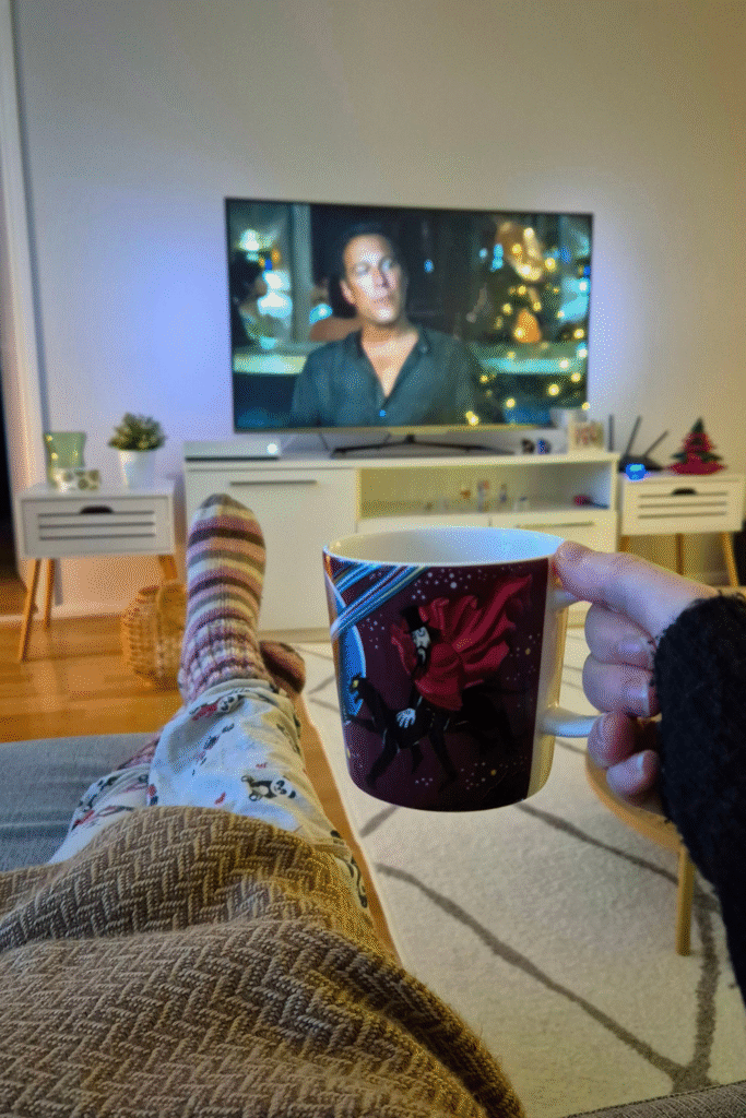 Winter hygge vibes in Finland: enjoying coffee while watching TV at home.