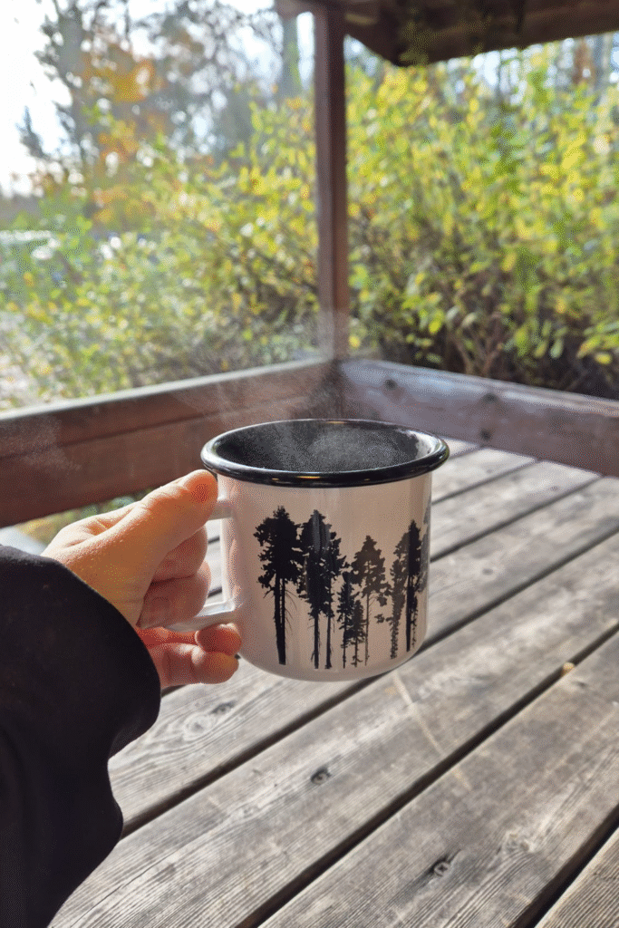 Enjoying a steaming cup of coffee from a thermos during a Finnish winter hike.