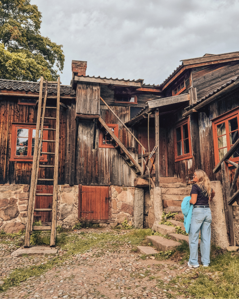 Traditional Finnish wooden houses at Luostarinmäki Handicrafts Museum on a sunny summer day.