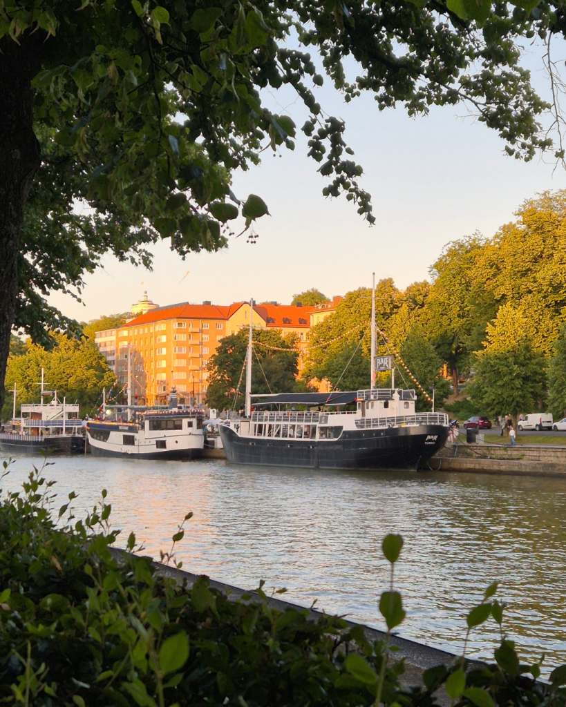 Evening sunshine over the Aura River with riverside boats in Turku, Finland.