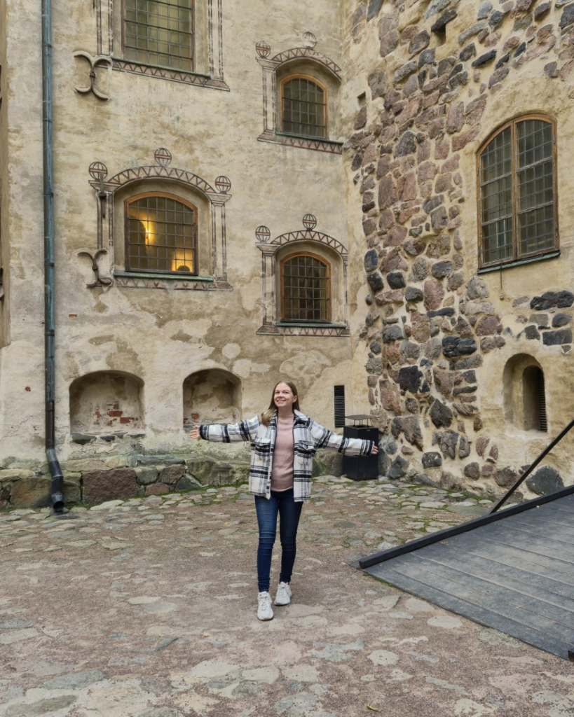 Historic courtyard inside Turku Castle surrounded by medieval stone walls in Turku, Finland.