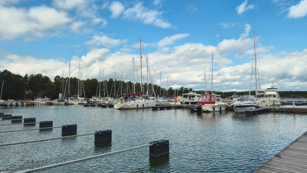 Nauvo harbour in Finland with boats, waterfront buildings and the sea.