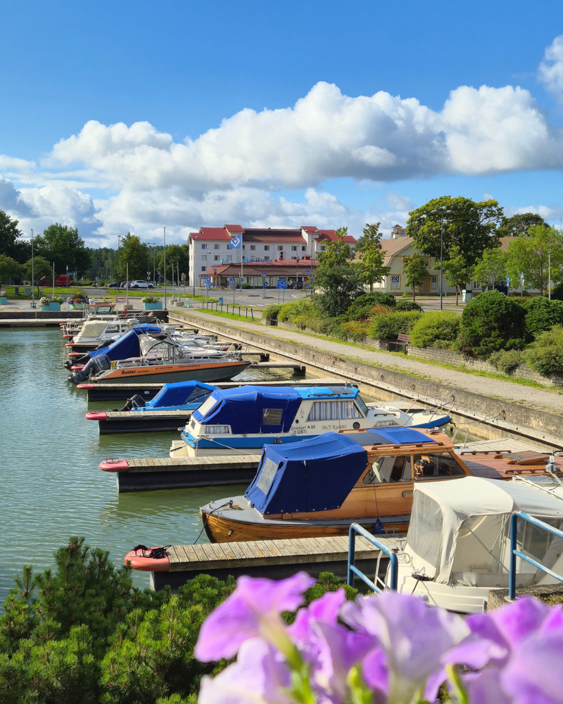Waterfront view in Parainen, Finland, with boats, flowers and the sea.