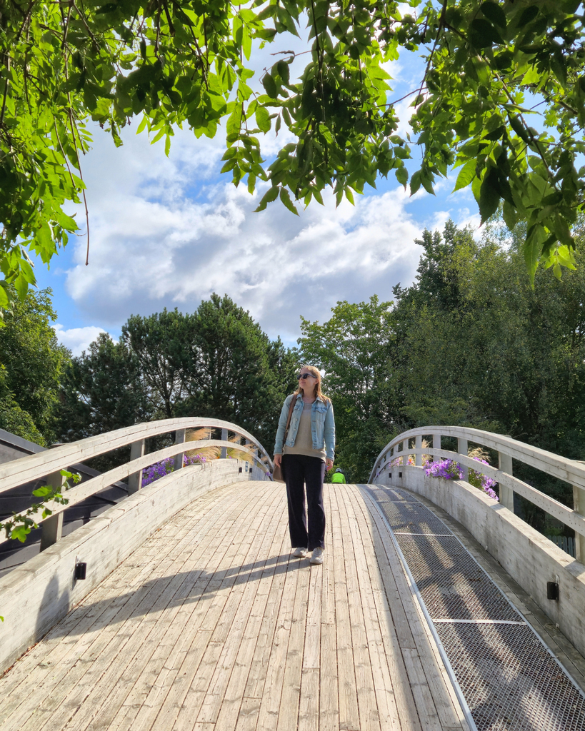 Woman standing on a bridge over the water in Parainen, Finland.
