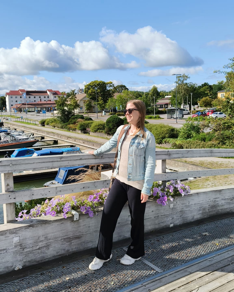 Woman on a bridge in Parainen, Finland, with the waterfront in the background.