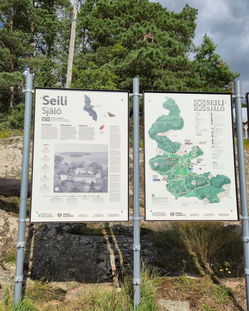 Directional signs along a walking trail on Seili Island in the Finnish Archipelago.