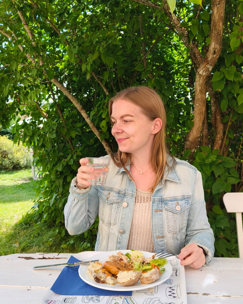 Woman eating at the outdoor seating area of the restaurant on Seili Island in the Finnish Archipelago.
