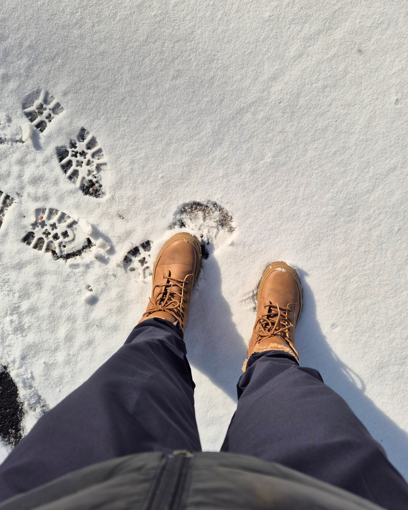 Winter boots standing on snow-covered ground in Finland.