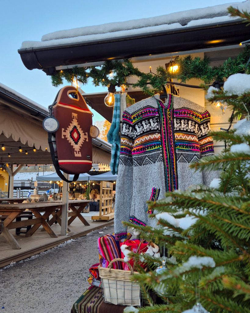 Christmas market at Tallipiha in Tampere, Finland, with traditional buildings and festive market stalls.
