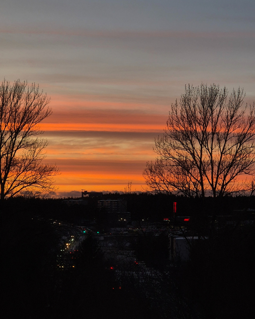 Winter evening view of Turku, Finland, with city lights and car headlights glowing along the streets after sunset.