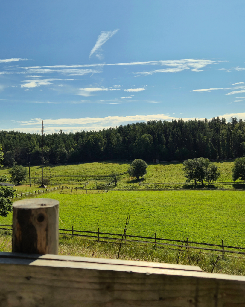 Green fields and countryside scenery at Kuralan Kylämäki open-air museum in Turku, Finland.