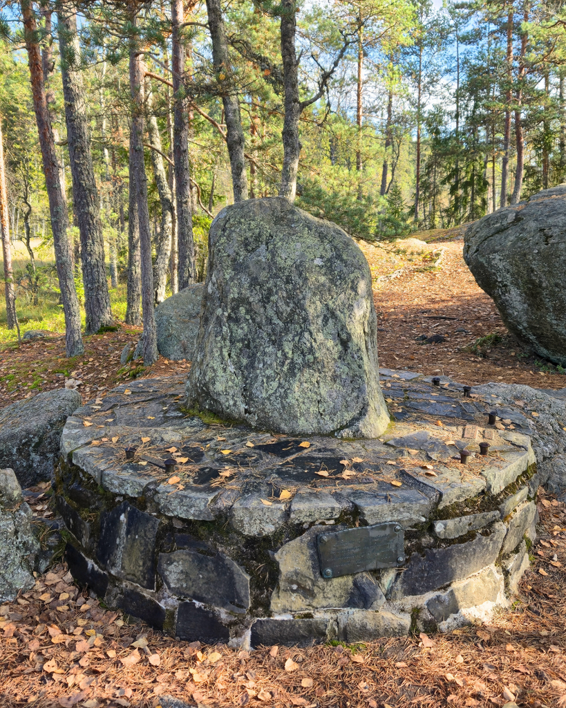 Kuhankuono boundary stone marking the historic meeting point of seven municipalities near Kurjenrahka National Park, Finland.