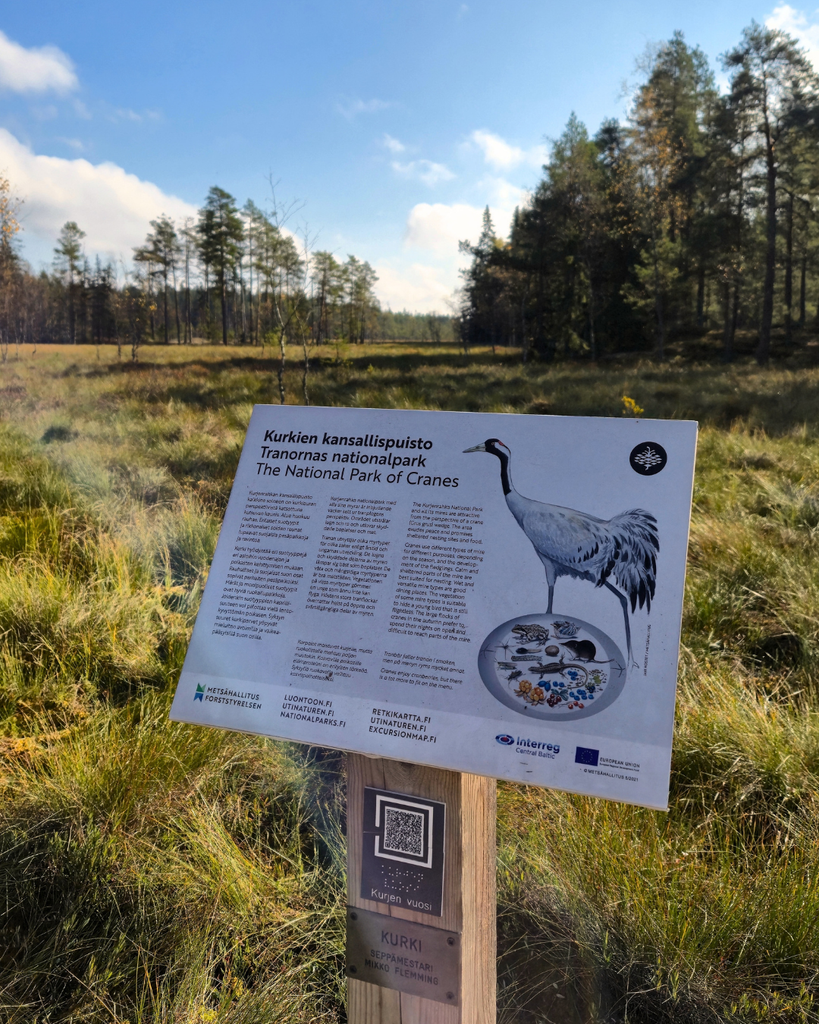 Information board explaining the crane and its connection to Kurjenrahka National Park in Southwest Finland.